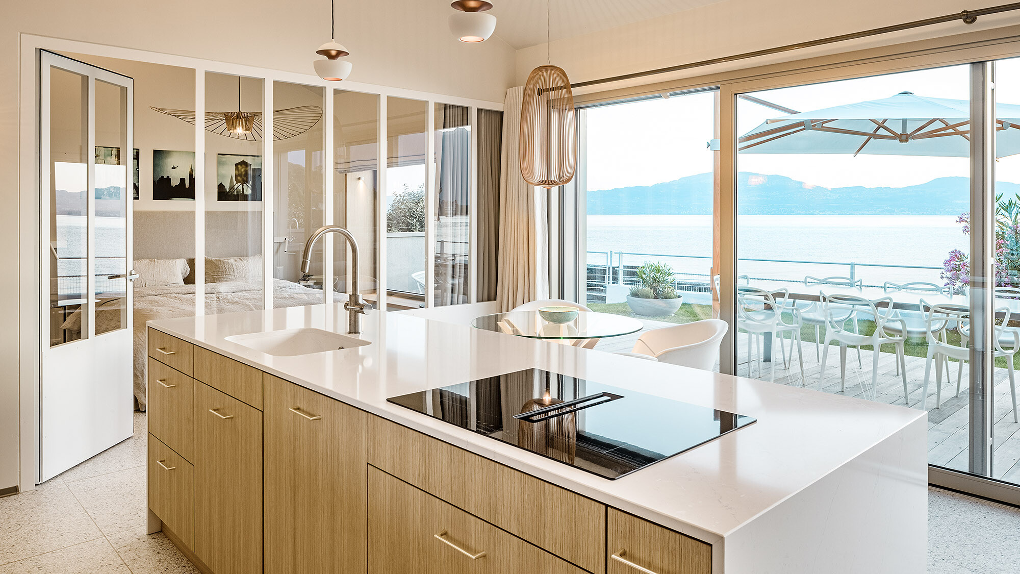 Interior view with the kitchen and bedroom, which are separated by a moveable glass wall.
