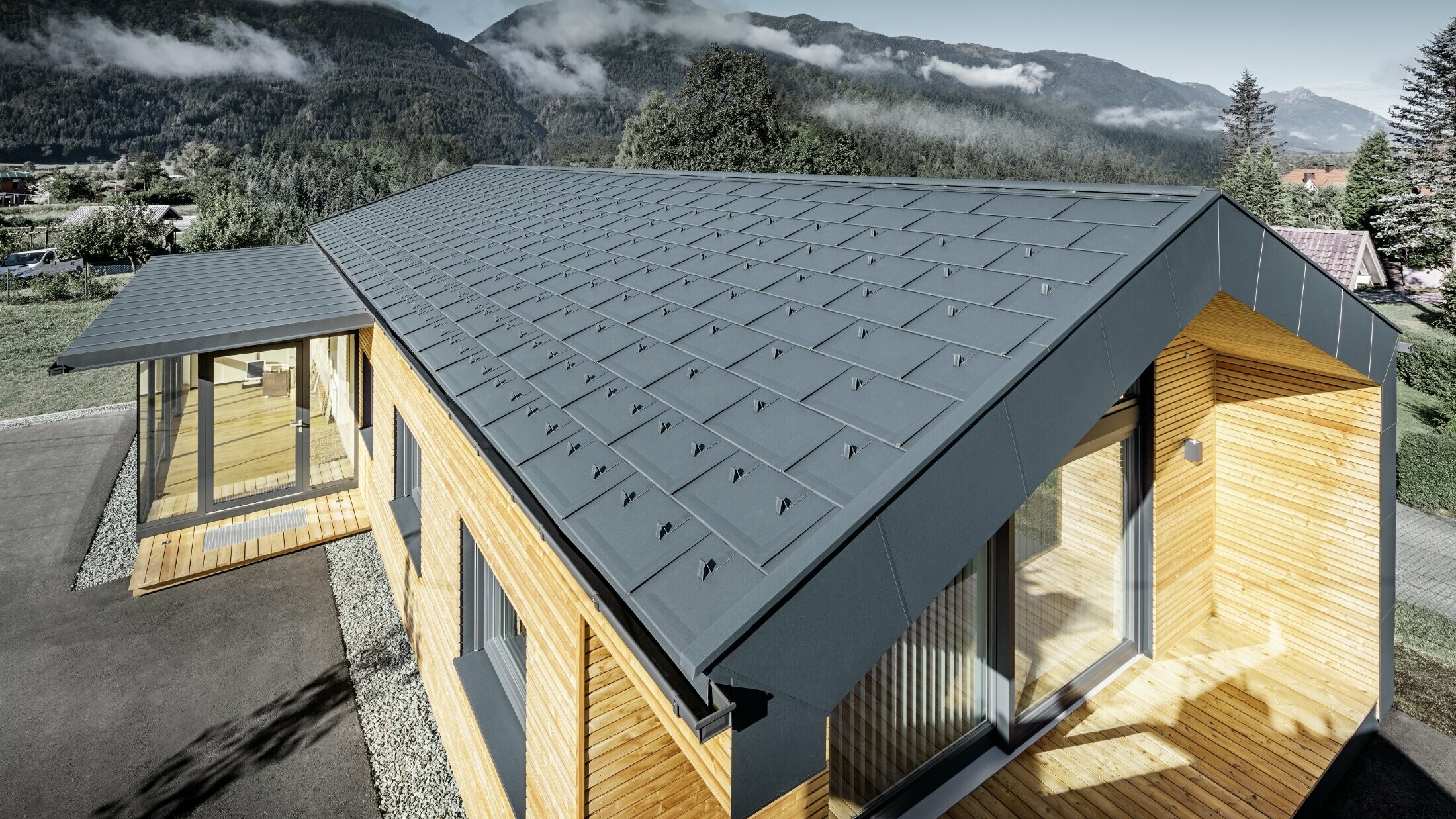 New office building of Holzbau Faltheiner with a larch wood façade, large windows and a PREFA roof in anthracite.