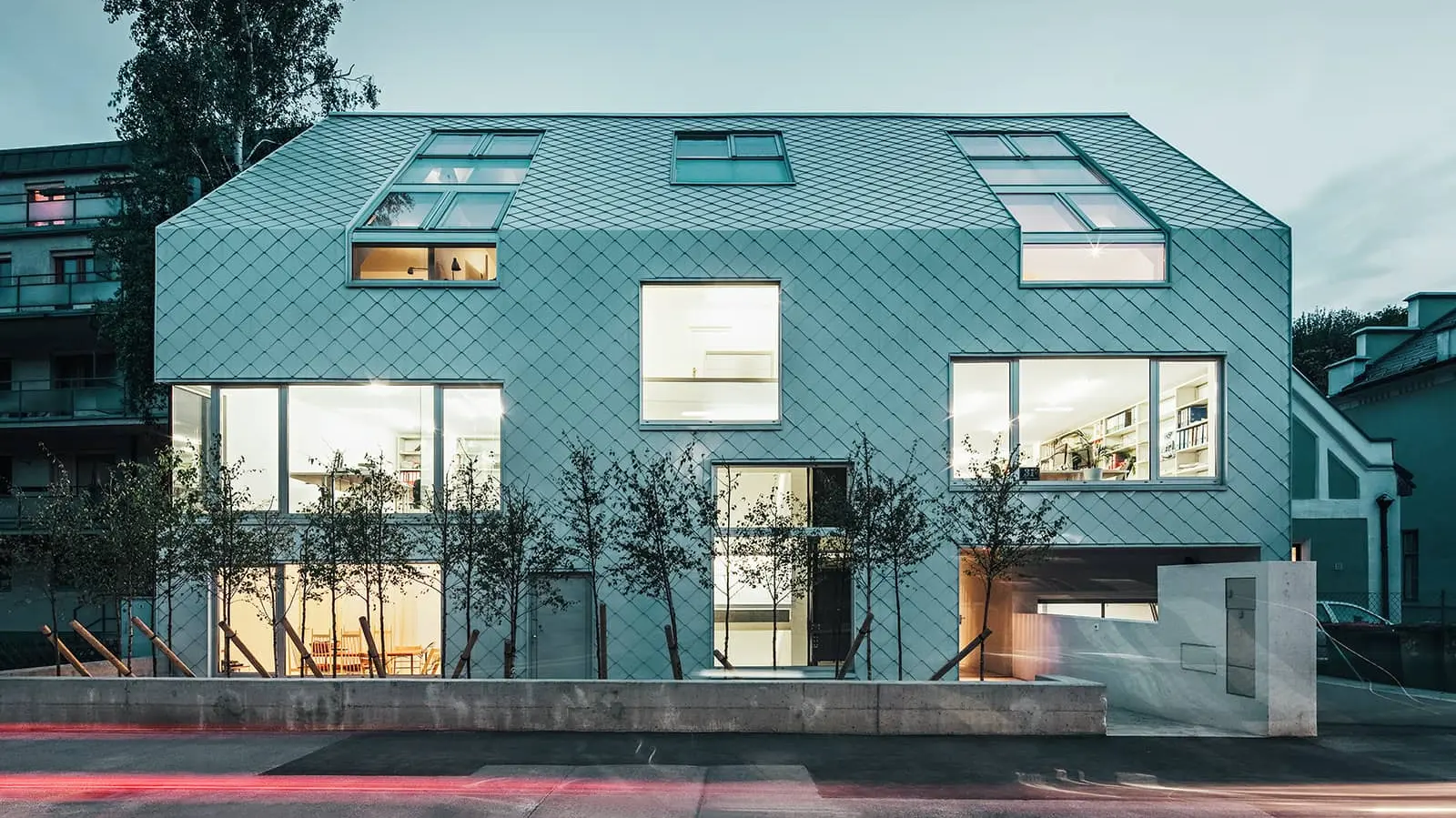 Outside view of the Superblock. The façade and roof are covered with PREFA rhomboid tiles in the colour white
