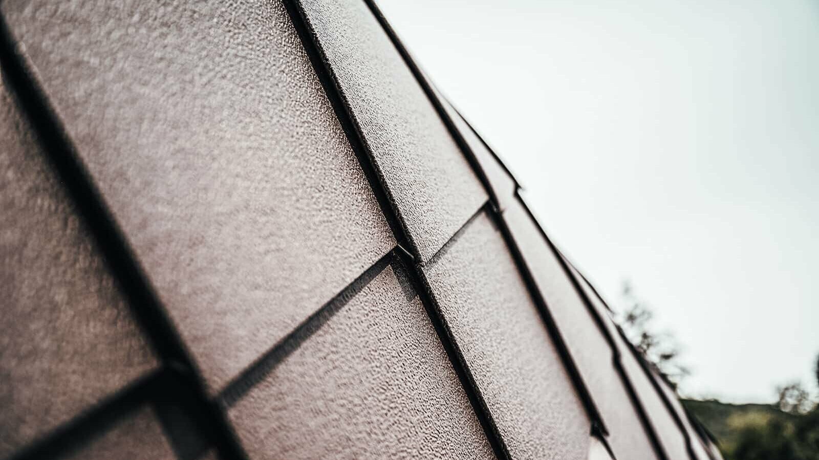 Close-up of PREFA roof and façade tiles in the colour nut brown.