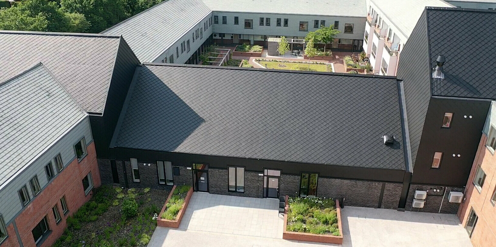 Bird's eye view of the residential care home in Preston that is clad with PREFA rhomboid roof and facade tiles 29 × 29 in P.10 Black.