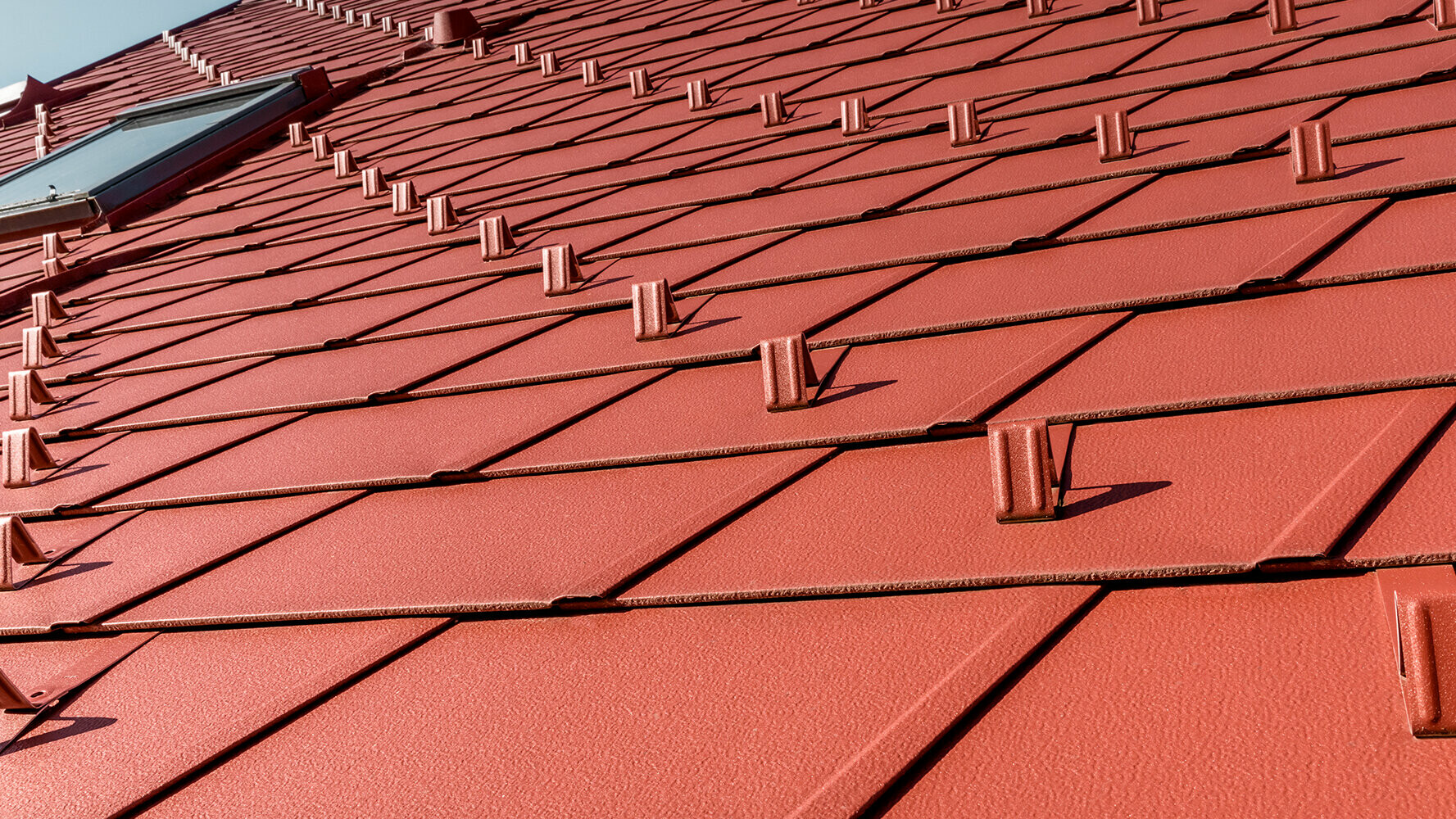 PREFA aluminium roof tiles in the colour oxide red