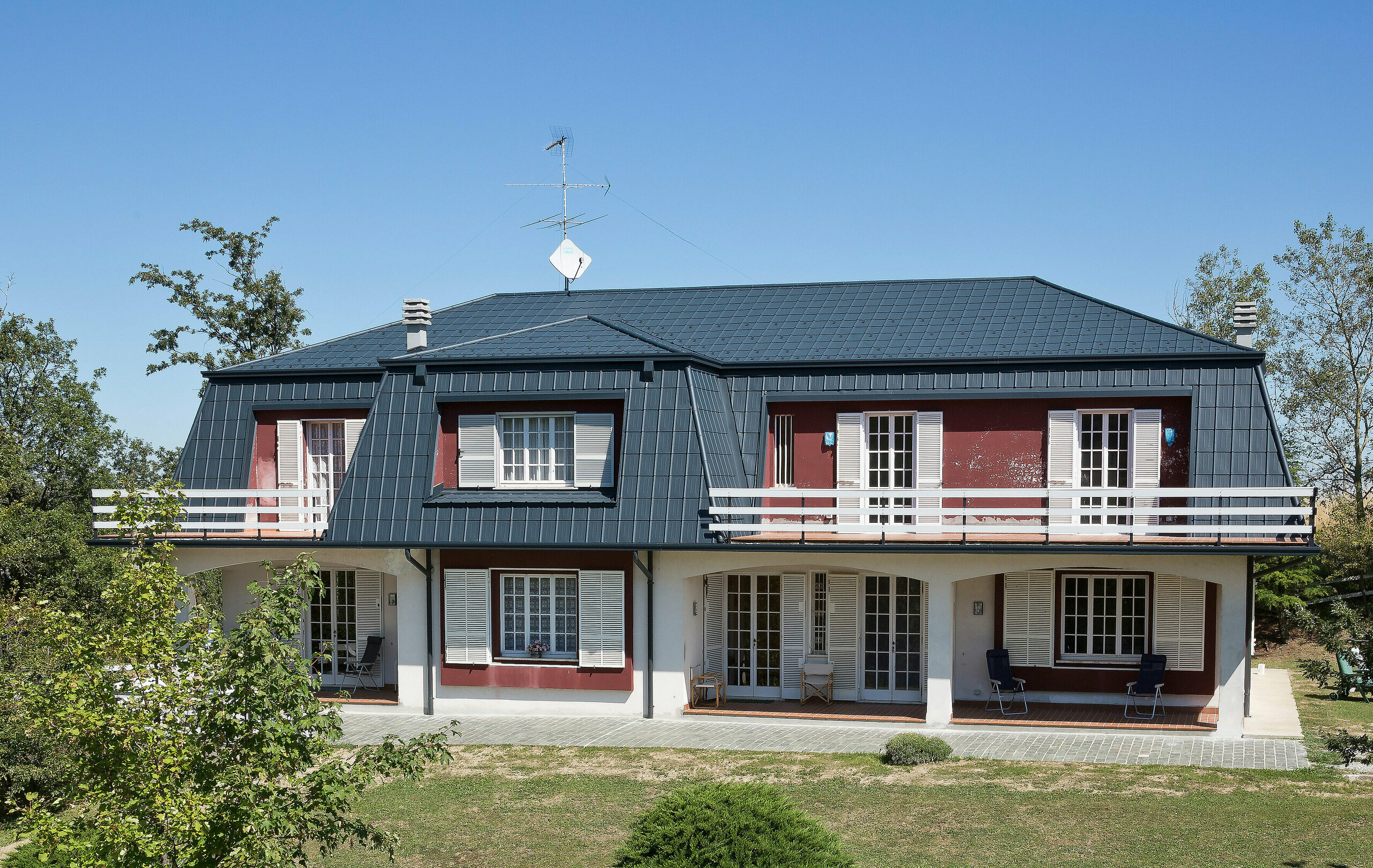 Villa in Italy with mansard roof, covered with PREFA roof tiles PREFA aluminium roof tiles in anthracite adorn the roof of this villa in Italy