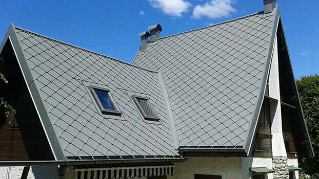 Steep gable roof clad with PREFA rhomboid roof tiles.