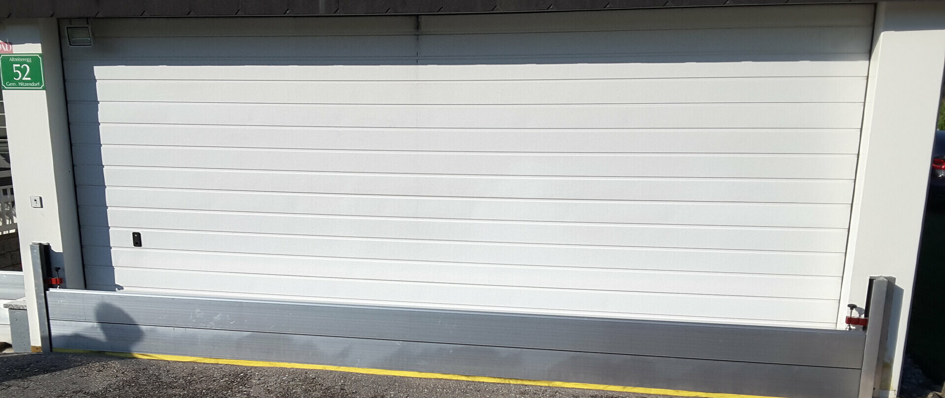 Garage door protected with PREFA flood protection 