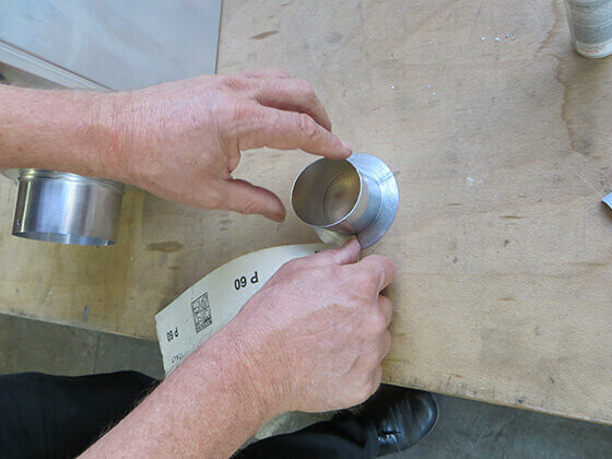 Roughen the bonding flange on the PREFA outlet in plain aluminium.