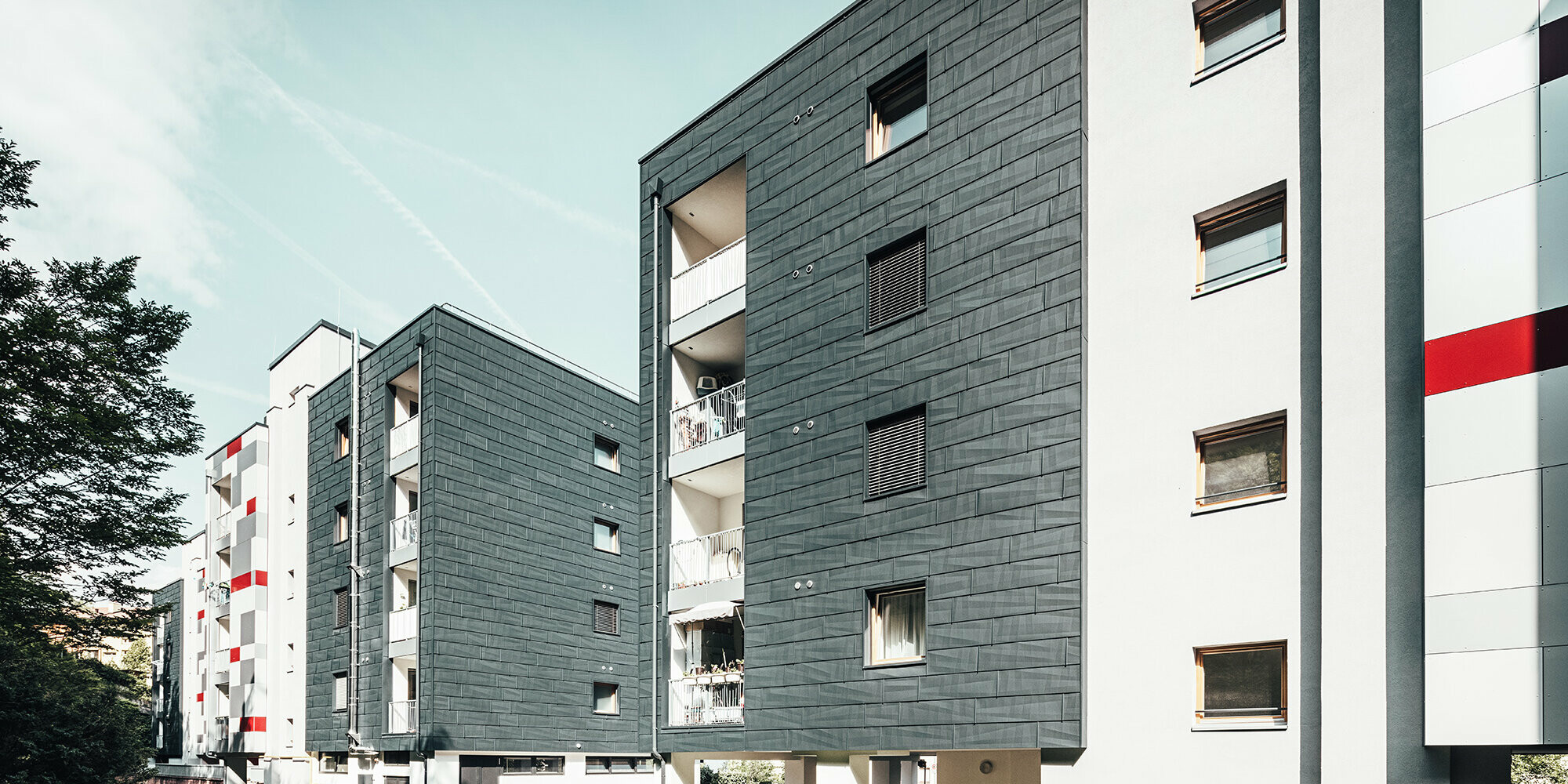 Slightly slanted aerial view of three apartment blocks.