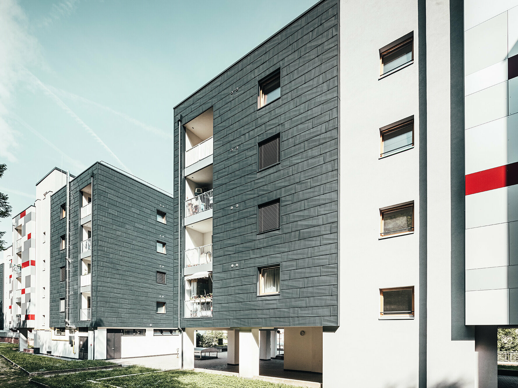 Slightly slanted aerial view of three apartment blocks.