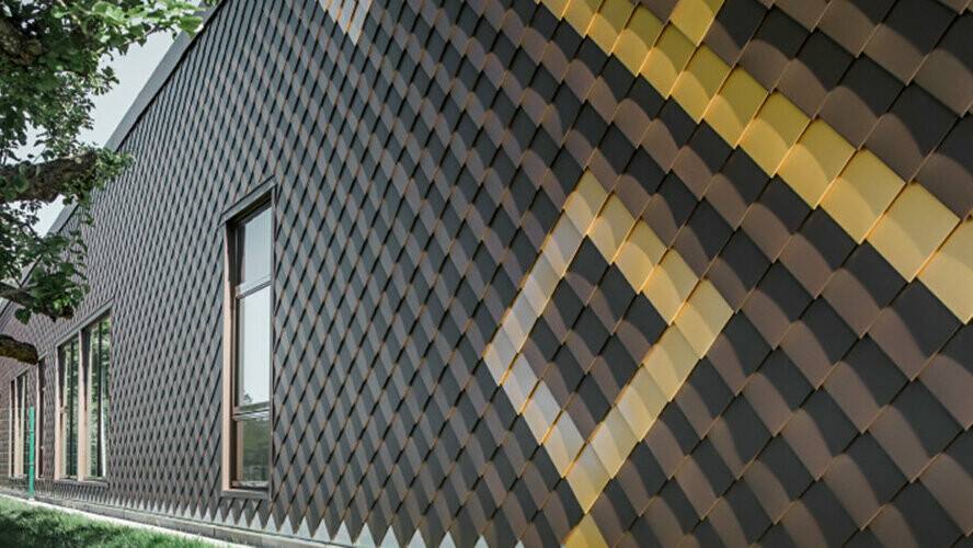 Façade with brown 20 x 20 PREFA rhomboid façade tiles. Gold rhomboid tiles were used to create a pattern on the façade.