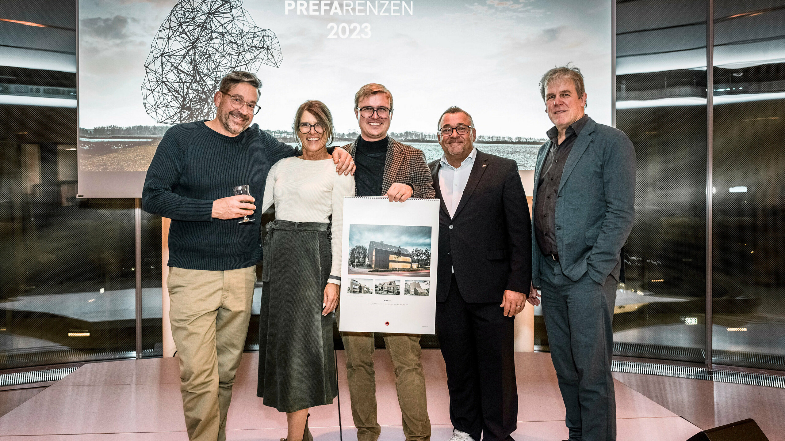 Architectural office lynx architecture, installer Matthias Engel holding the calendar and Thomas Hill on the stage.