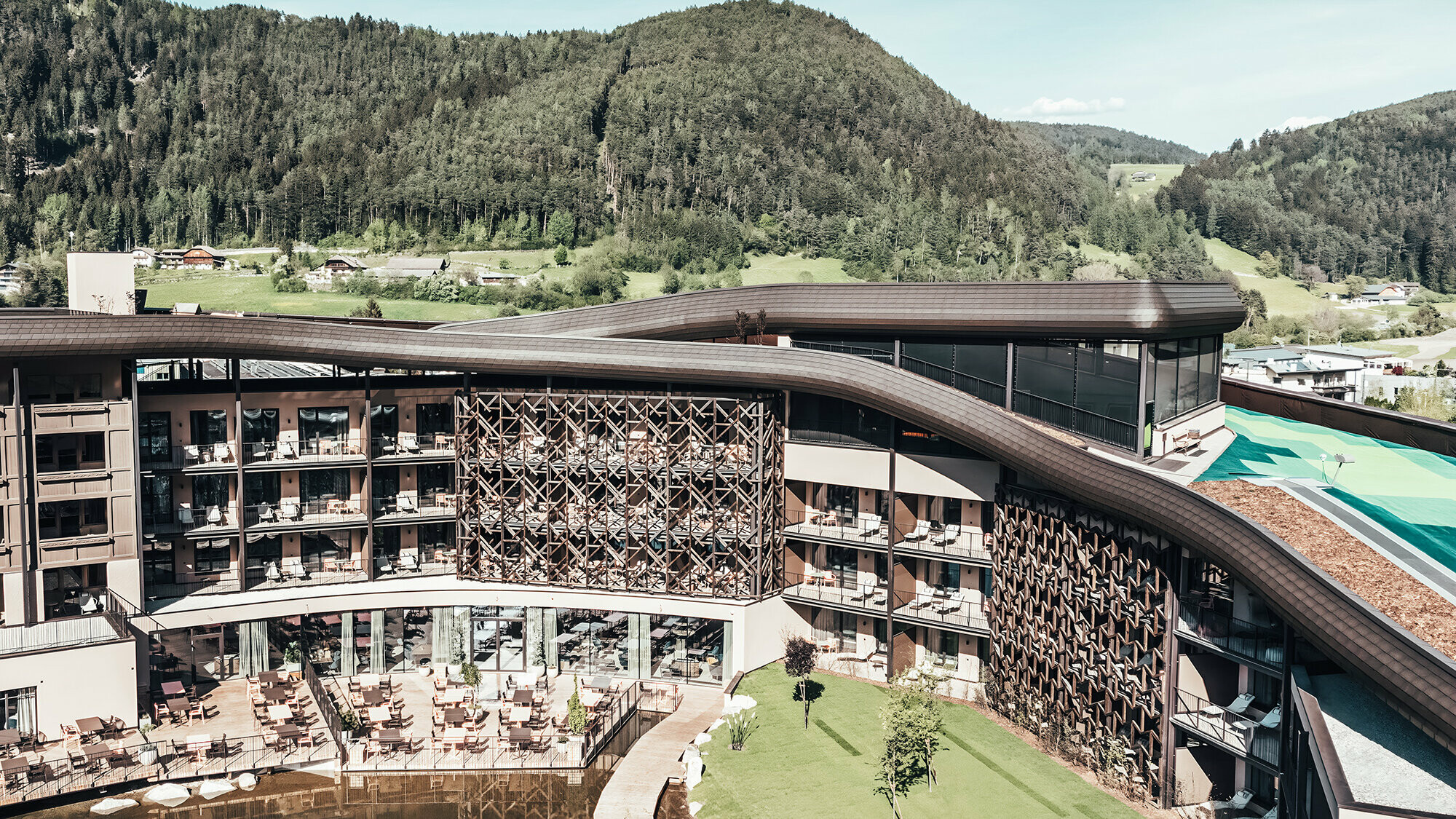 View of the Falkensteiner Hotel with hilly background.