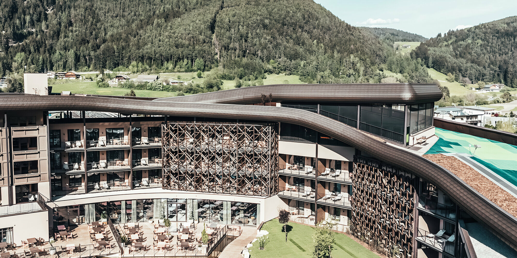 View of the Falkensteiner Hotel with hilly background.