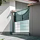 The picture shows a green entrance gate. PREFA's mobile flood protection was installed in front of it to prevent water from entering.