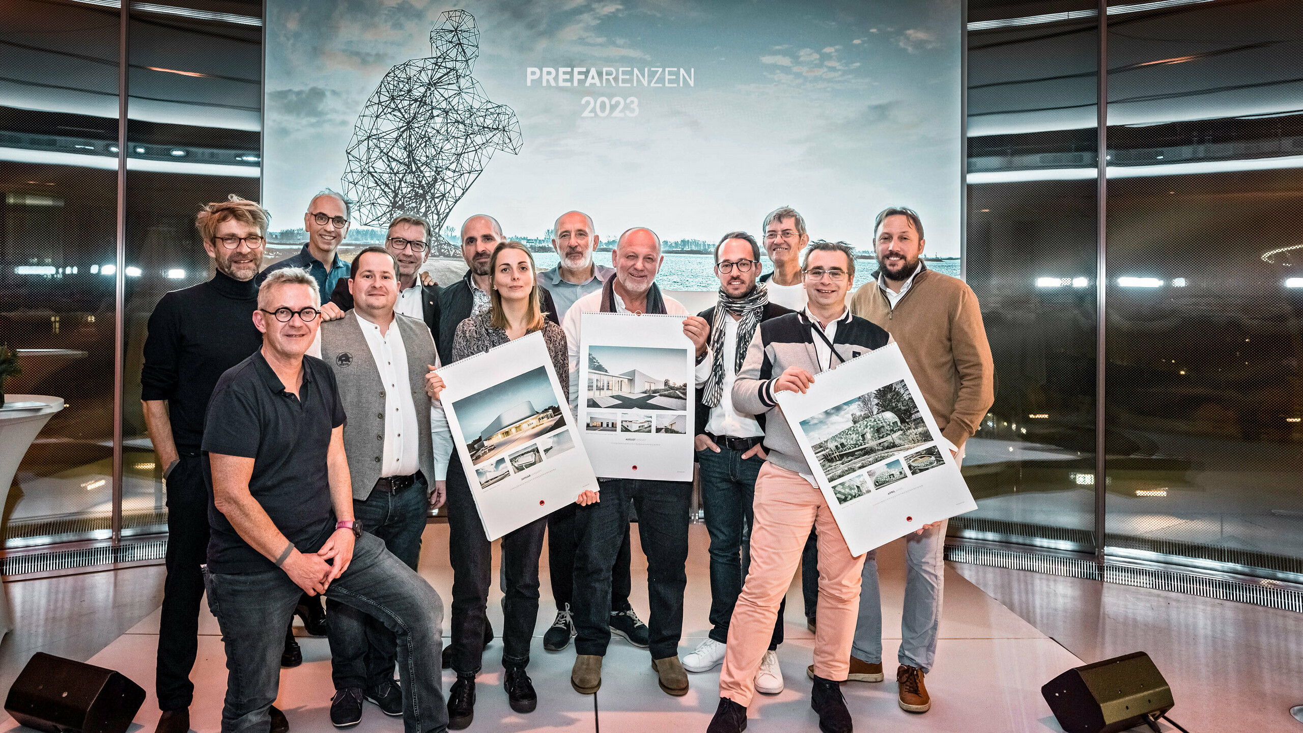Some of the participating architects, installers and PREFA national subsidiaries on the stage with the PREFARENZEN calendar in their hand.