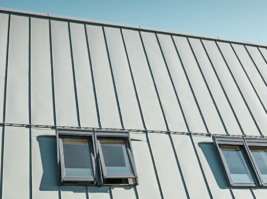 PREFALZ seamed roof in P.10 zinc grey with roof windows