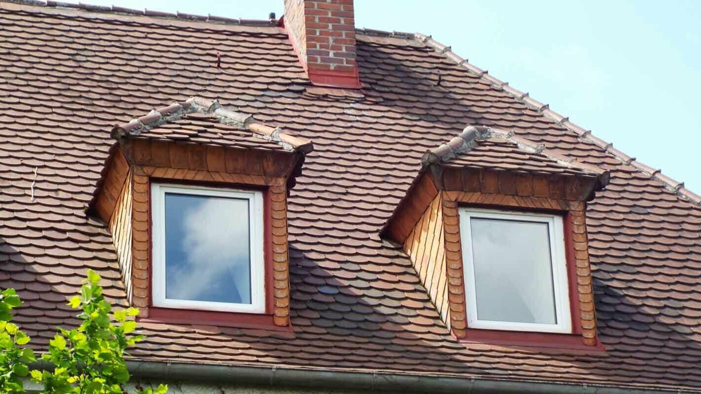 Before roof renovation with a tile-effect hipped gable roof dormer with PREFA rhomboid roof tiles