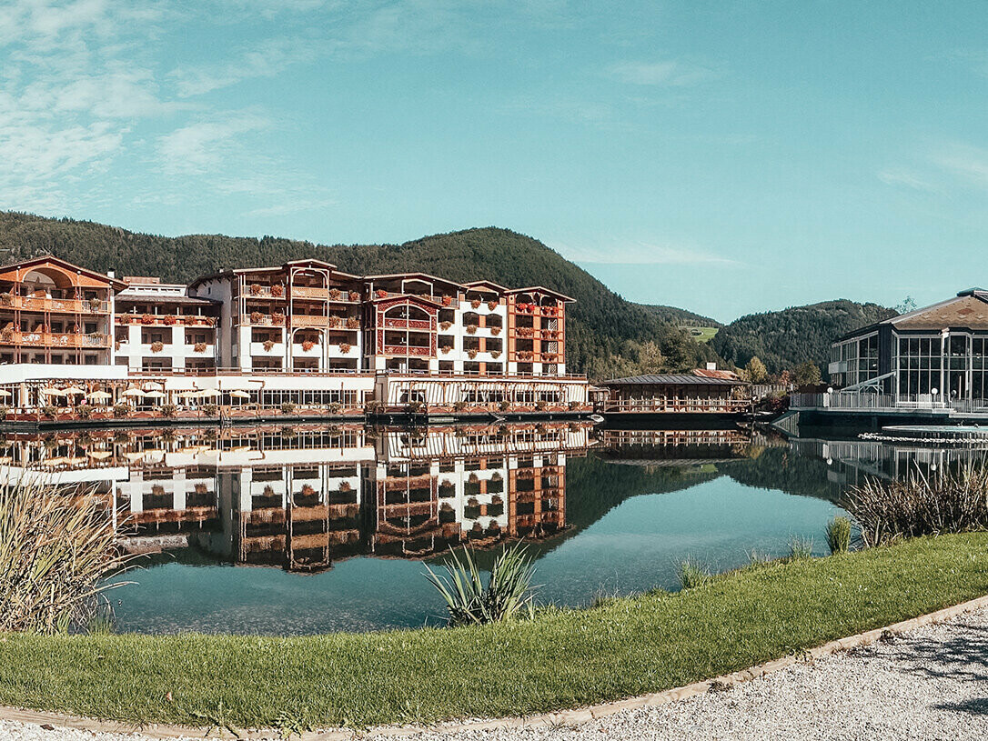 Picture of the hotel before the conversion, a lake is before the hotel