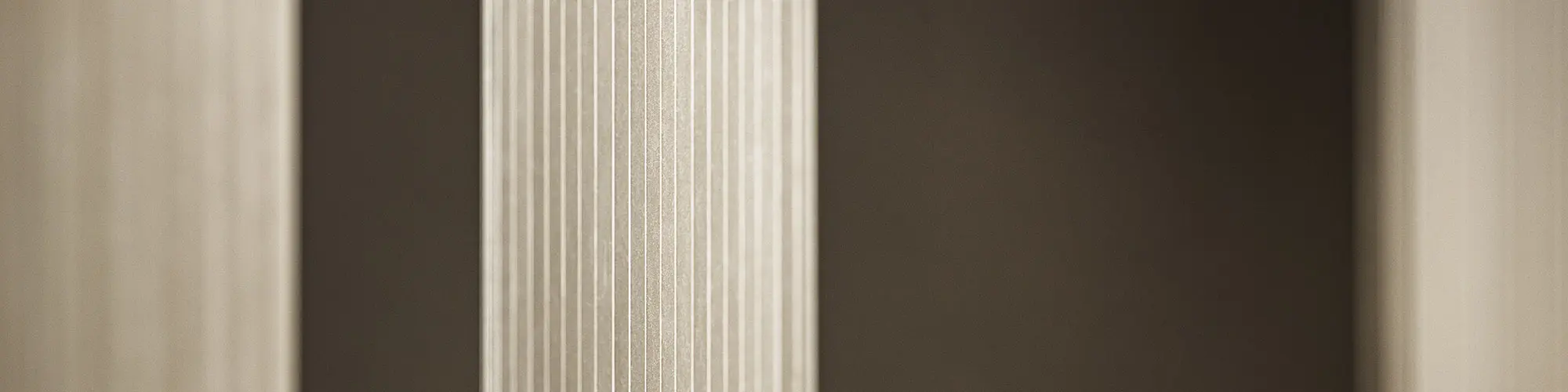 Detailed view of the bronze-coloured façade's serrated profile in various shades of gold and brown.