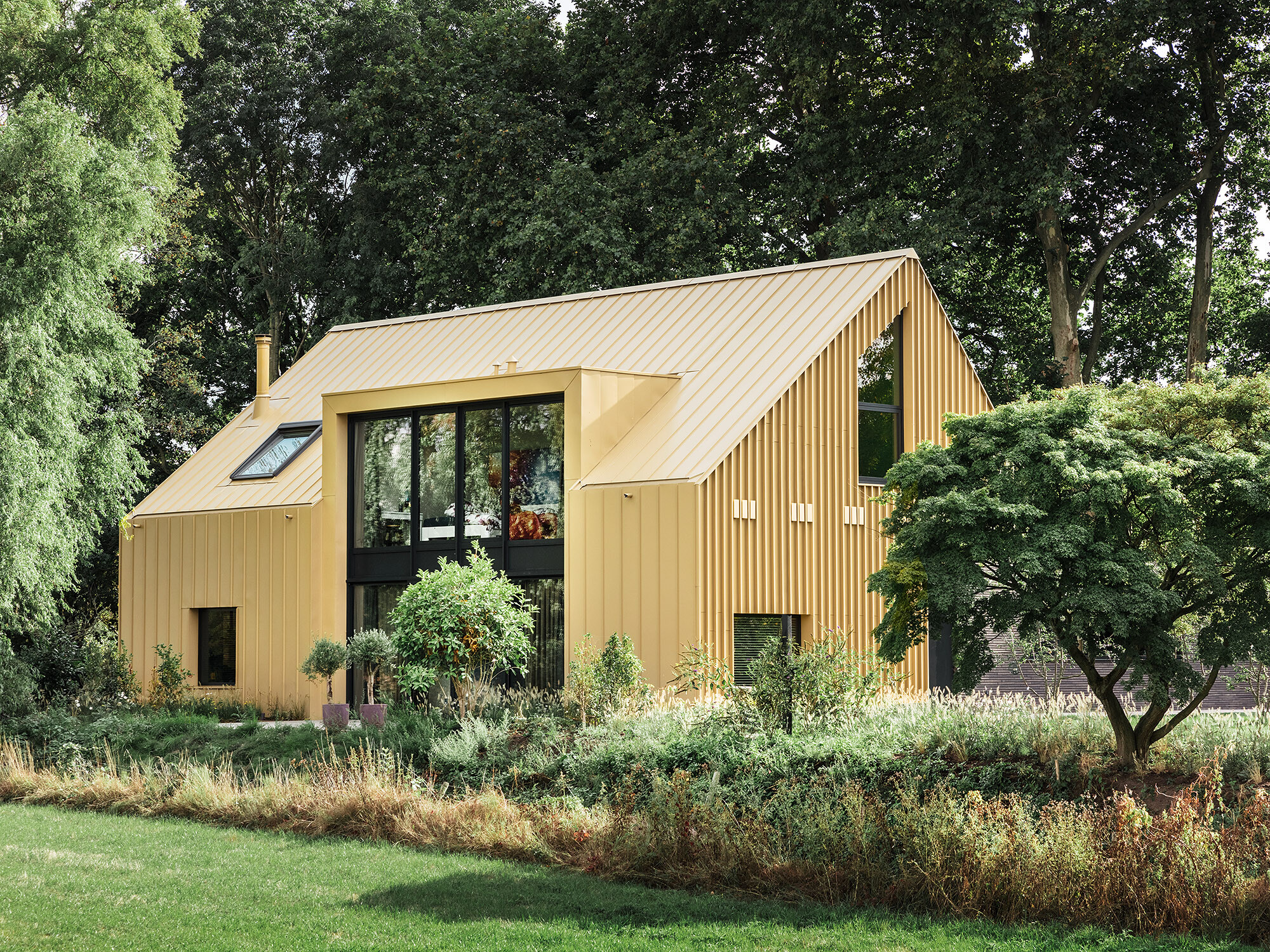 The building from a normal perspective, framed by trees and lush greenery.