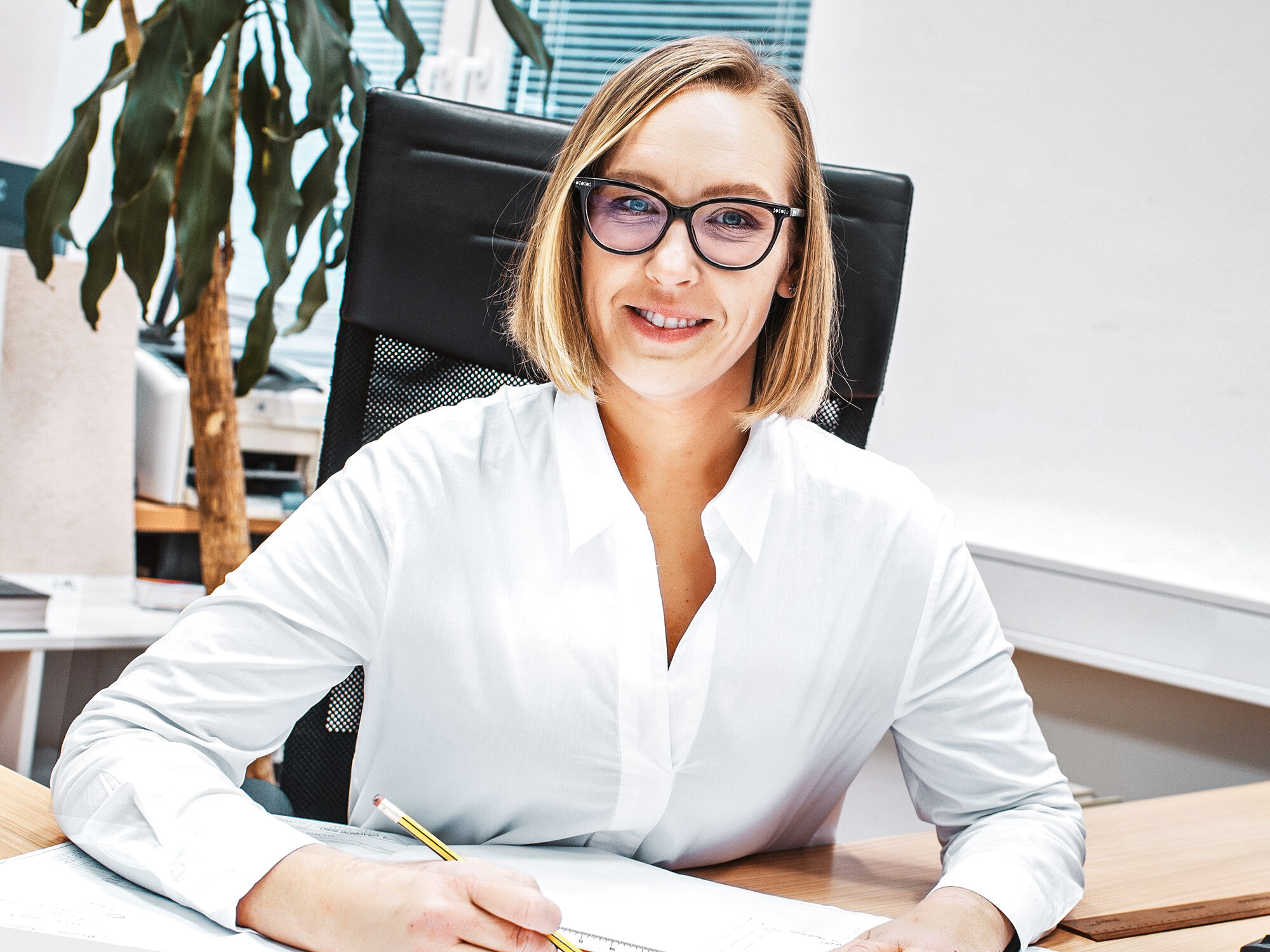 Portrait of the lead architect Živa Repovž Zelenšek of Biro Repovž at her office desk.