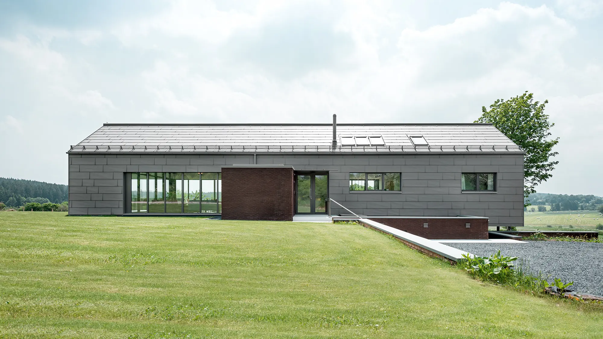 View of the building from the north side, you can see through it in certain sections due to the glazing.