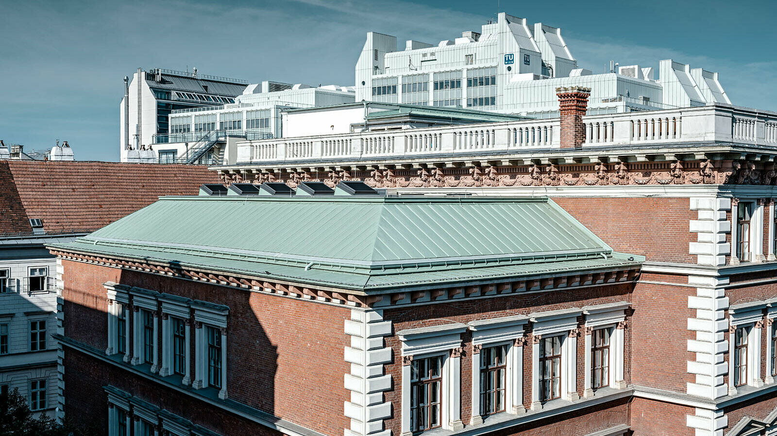 A picture of the protestant elementarty school at Karlsplatz, Vienna. The roof was clad with Prefalz in P.10 patina green. In the background the technical University of Vienna can be seen.