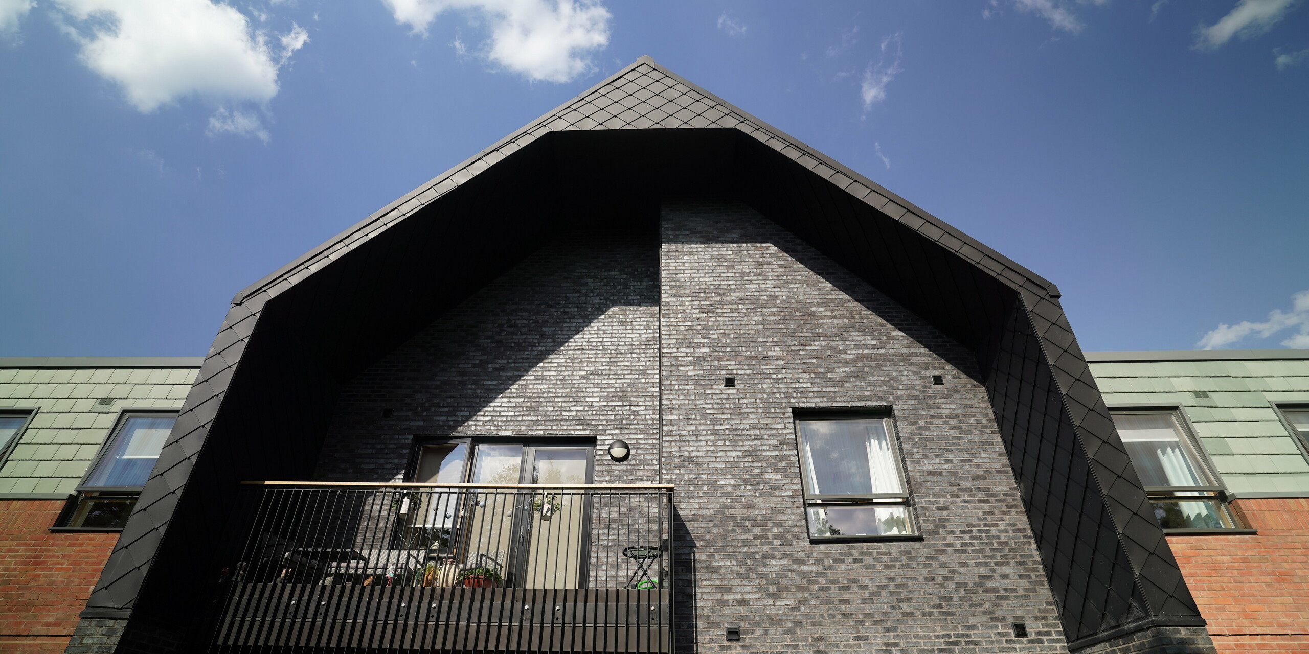 Balcony of a care facility in Preston framed with PREFA rhomboid tile 29 × 29 in P.10 Black