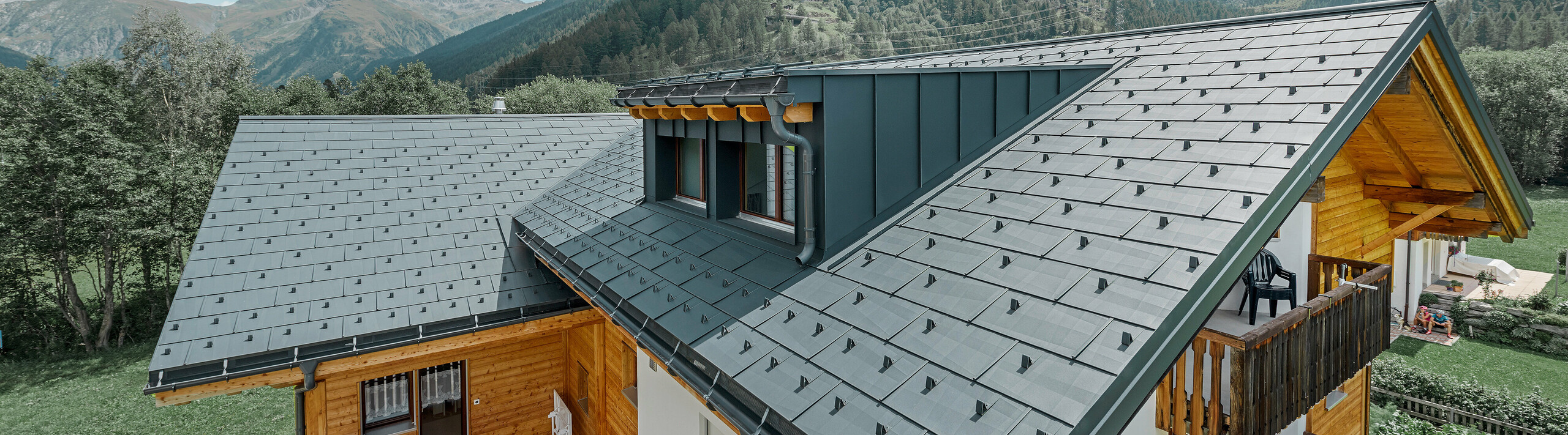 PREFA Obergoms Zuber roof system FX.12 roof panel anthracite Montanara Newly refurbished residential building with gabled roof and dormer. The roof was refurbished with the PREFA FX.12 roof panel in anthracite.