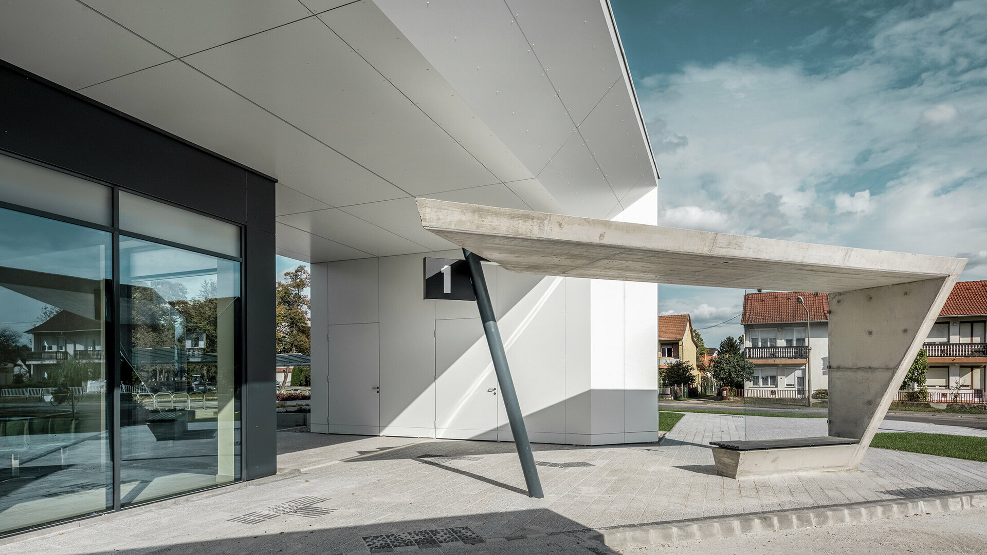 The new railway station in Lenti. The picture shows the bus stop number one. PREFABONd aluminium composite panels in the colour P.10 anthracite and pure white was used on the showed façade.