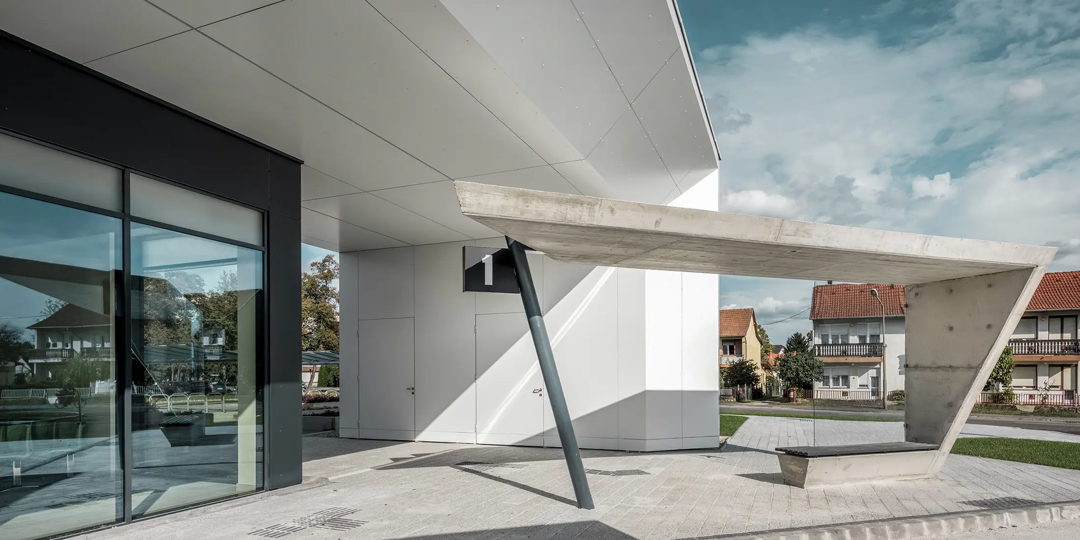 The new railway station in Lenti. The picture shows the bus stop number one. PREFABONd aluminium composite panels in the colour P.10 anthracite and pure white was used on the showed façade.