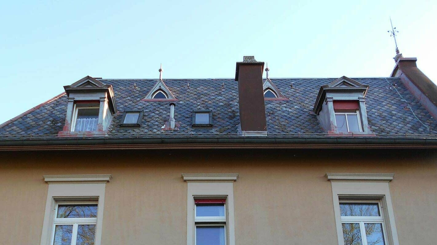 Old roof with charming dormers before roof renovation with PREFA rhomboid roof tiles