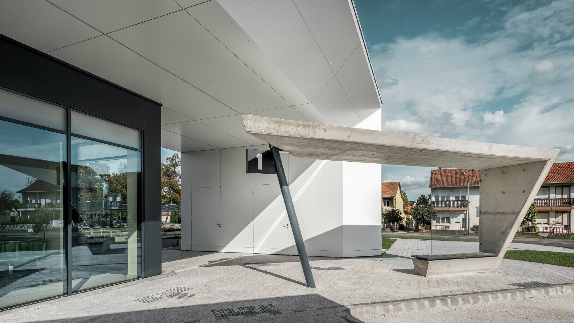 The new railway station in Lenti. The picture shows the bus stop number one. PREFABONd aluminium composite panels in the colour P.10 anthracite and pure white was used on the showed façade.