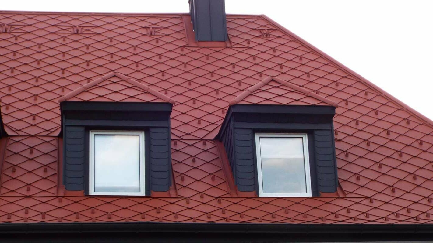 Tile-effect roof renovation of a hipped gable roof dormer with PREFA rhomboid roof tiles