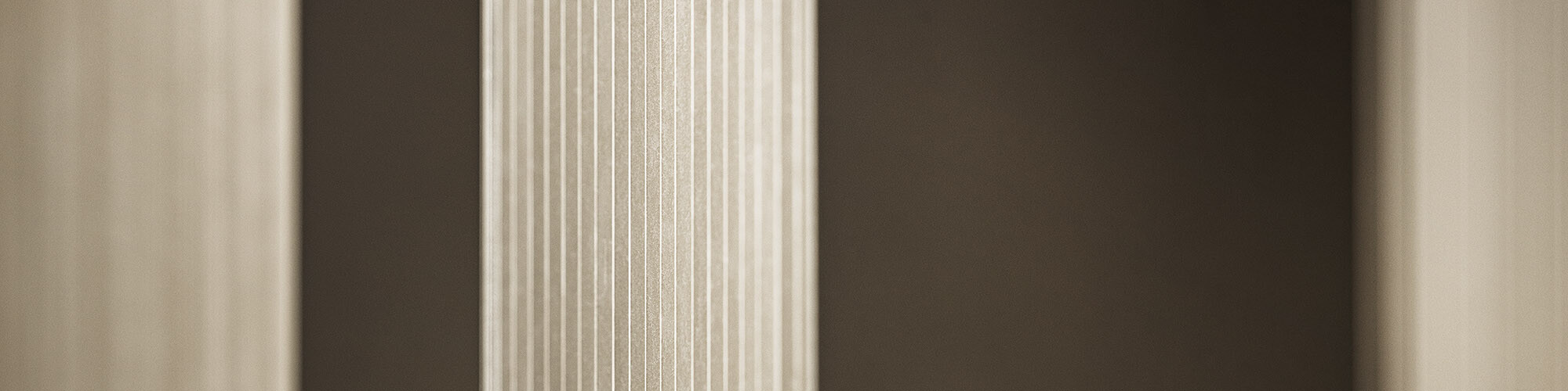 Detailed view of the bronze-coloured façade's serrated profile in various shades of gold and brown.