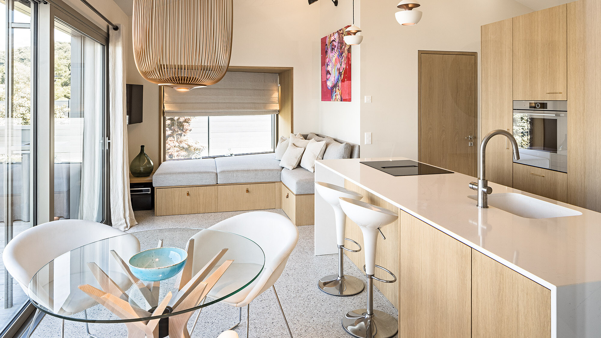 View of the tasteful interior with the kitchen, dining table and seating.