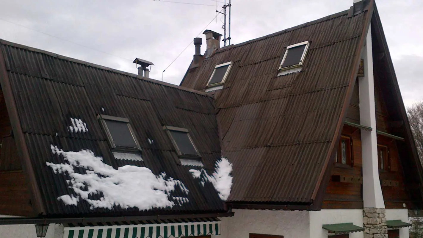 Steep roof area before roof renovation with PREFA rhomboid roof tiles including window surrounds
