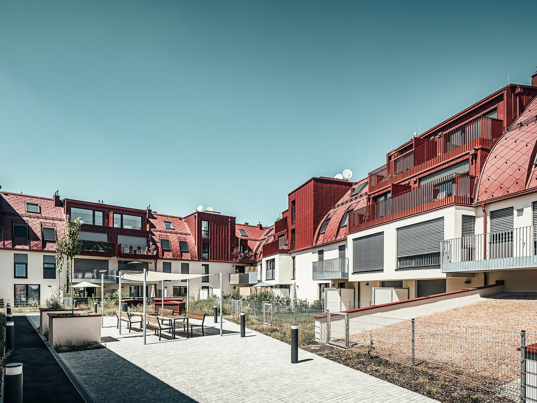 View of the inner courtyard with covered seating and green areas.