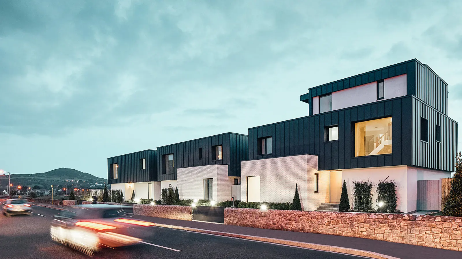 A picture of the three terraced houses in dust. Cars are passing by the houses.