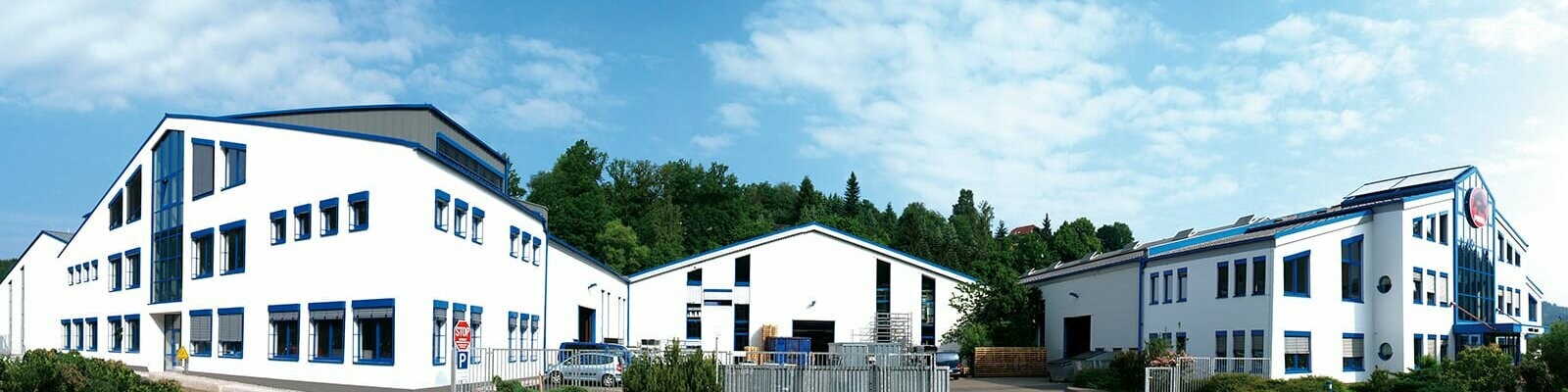 PREFA company building with white façade and blue windows