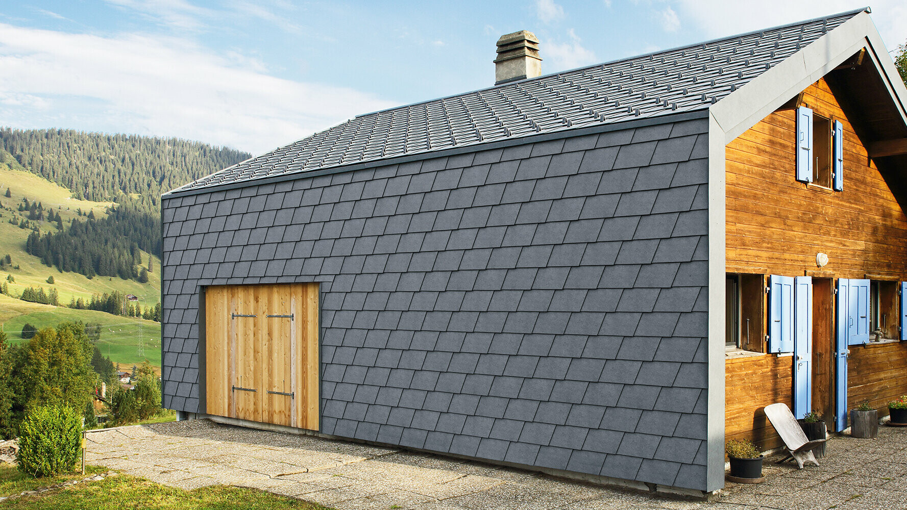 Modern detached house clad with PREFA façade shingles in anthracite and wooden elements.