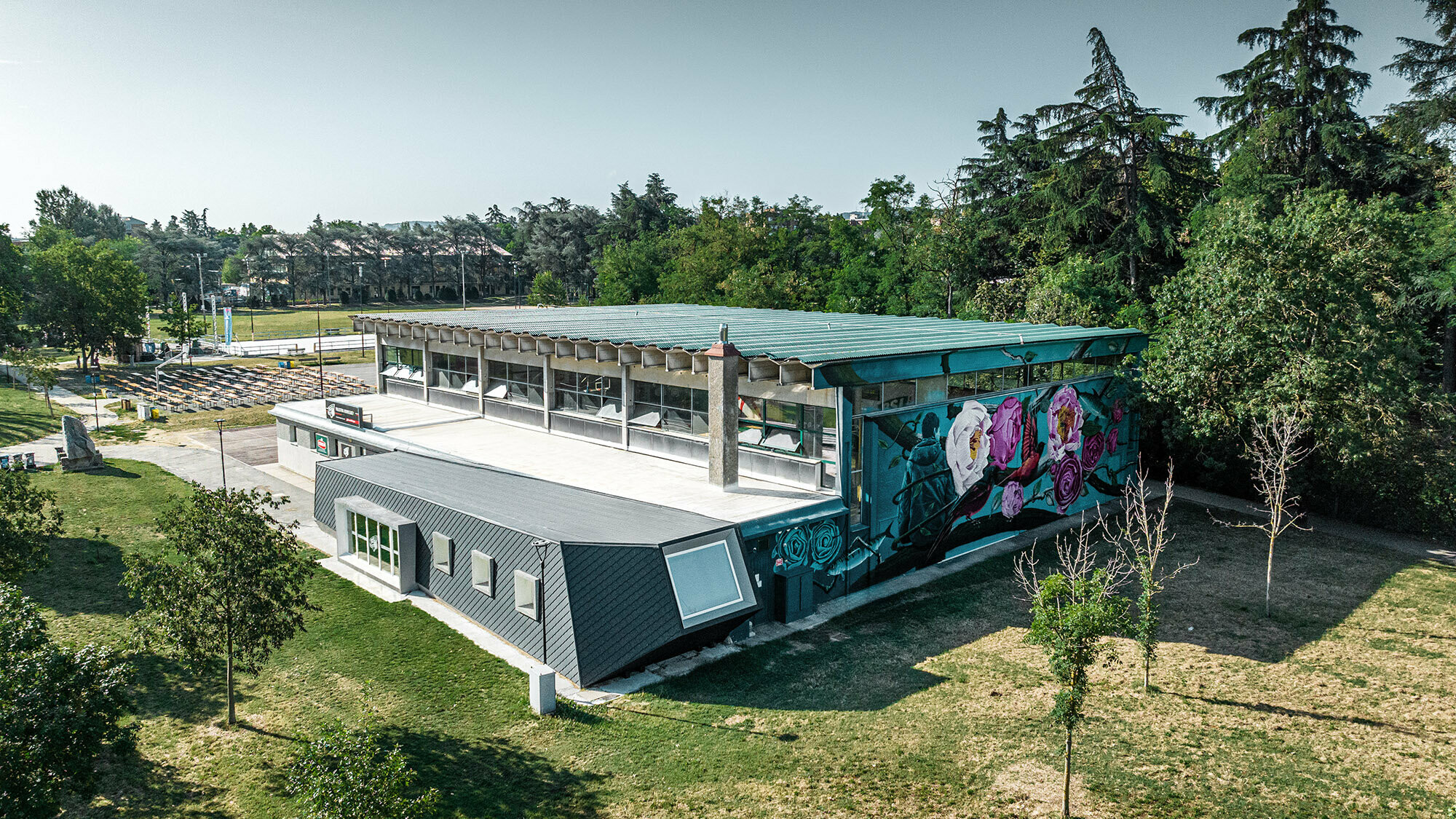 A bird's eye view of the Rodriguez gymnasium and its extension surrounded by the park grounds.