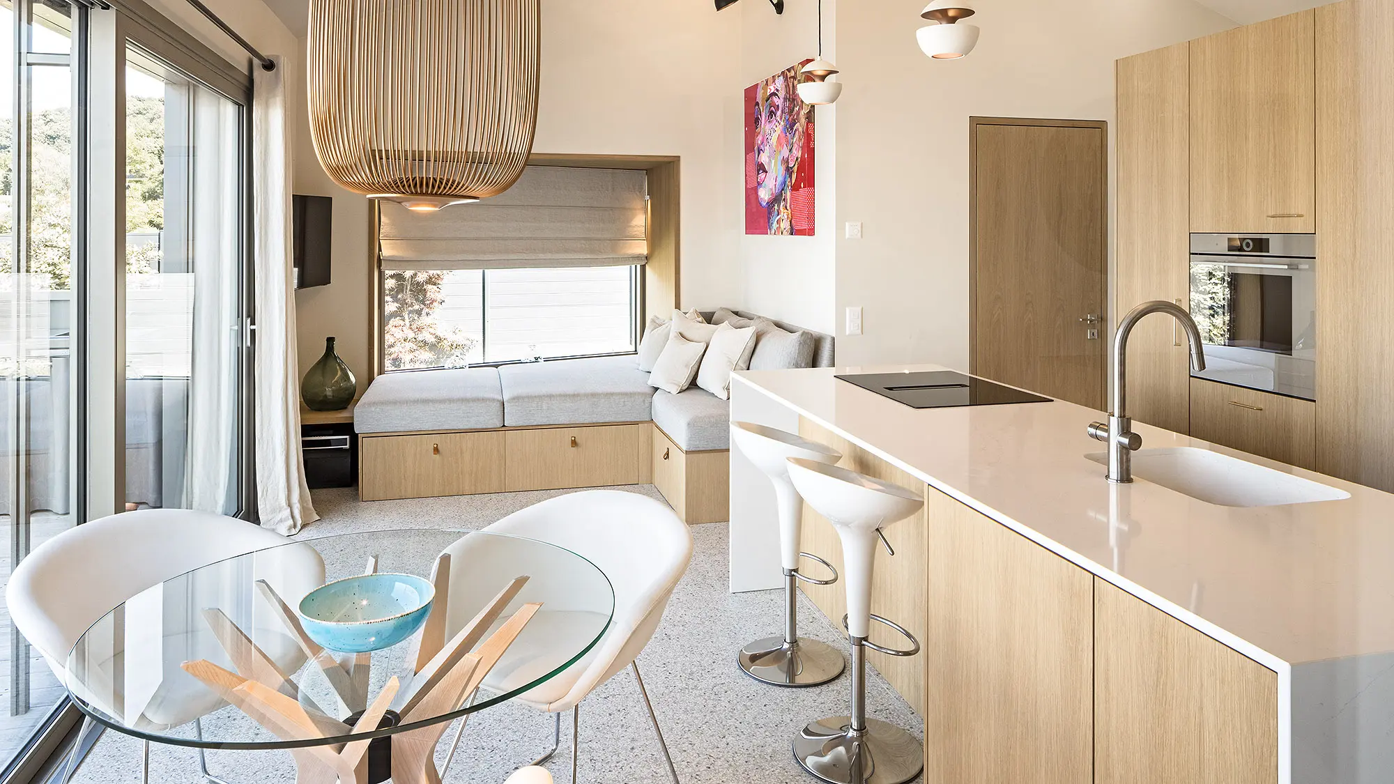 View of the tasteful interior with the kitchen, dining table and seating.