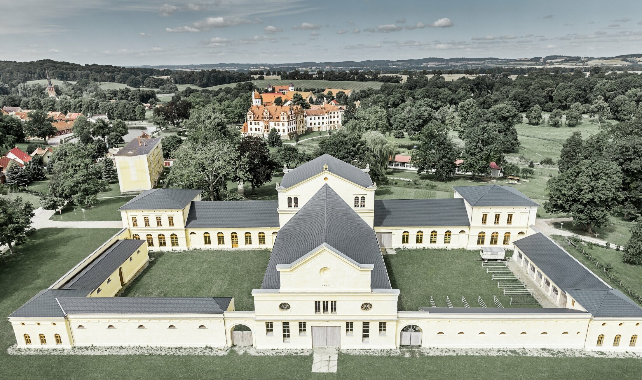 Aerial view of the stables in Basedow; the newly refurbished castle in Renaissance style also has a new roof with PREFA roof shingles in anthracite.