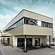 Modern extension with workshop and office of Guggisberg Dachtechnik with PREFA aluminium composite panels in bronze