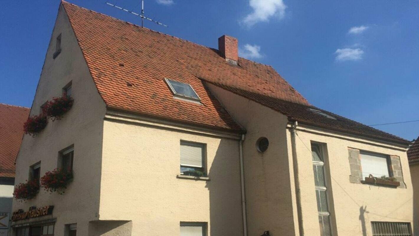 House before roof renovation with PREFA roof tiles