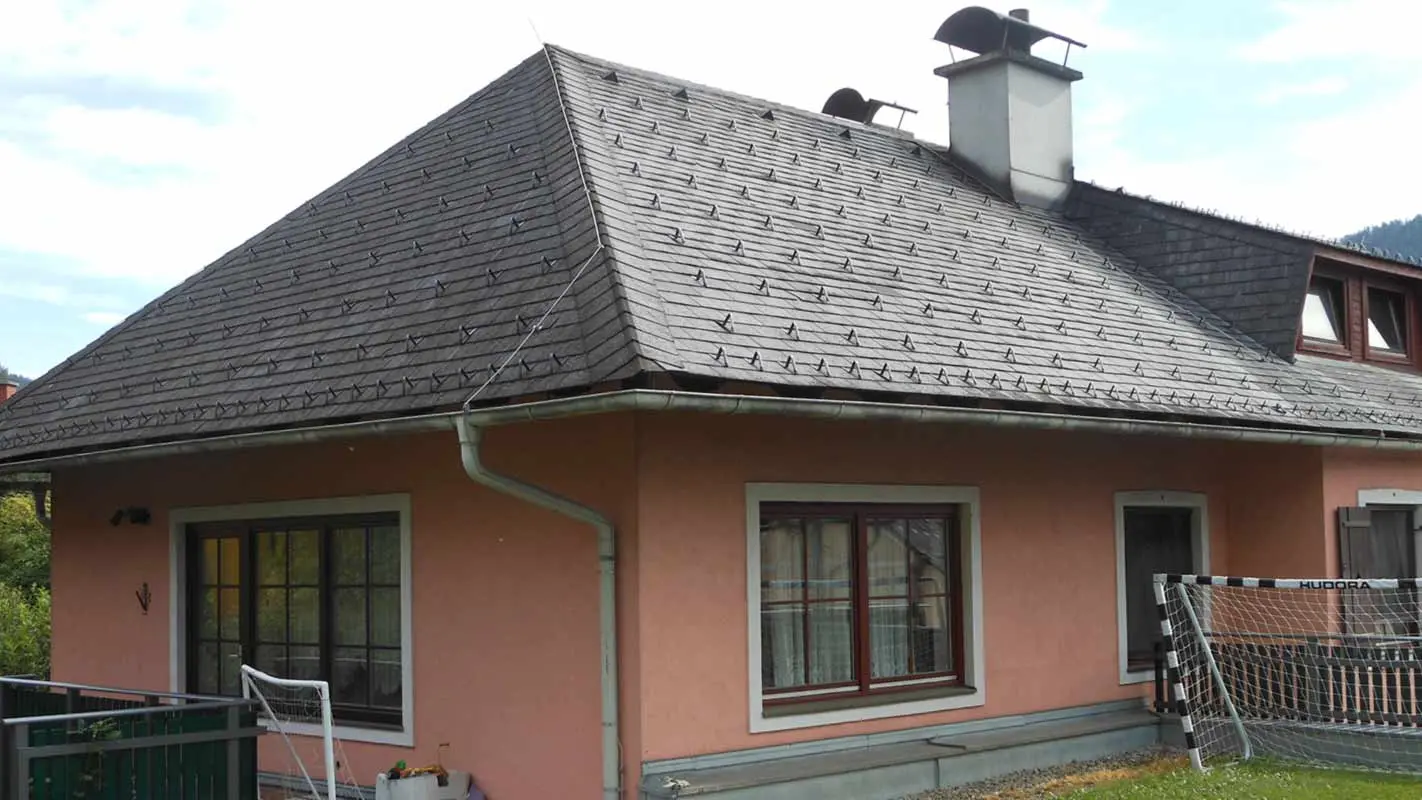 Roof renovation of a house with a hipped roof with a trapezoidal dormer using PREFA shingles