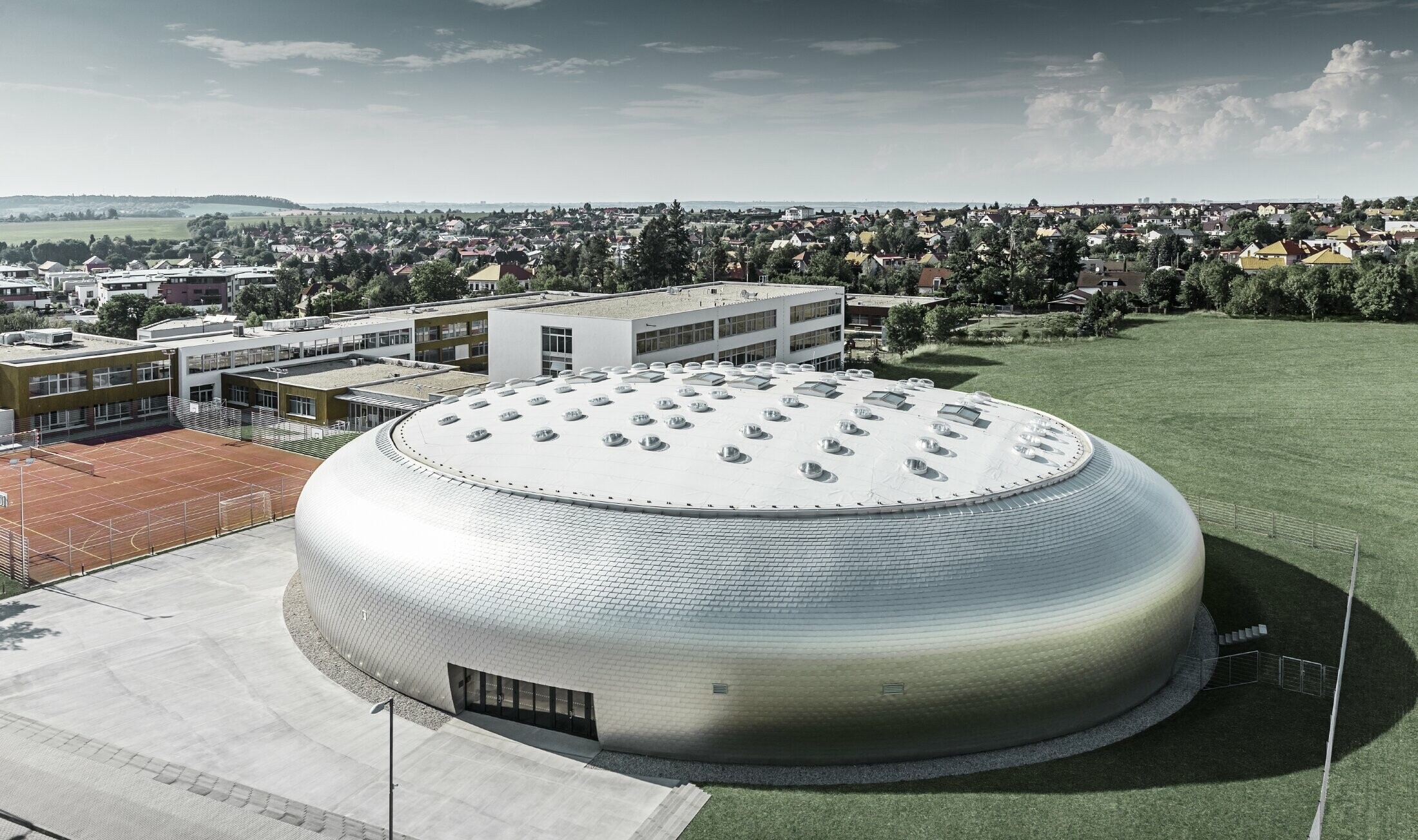 Aerial view of the sports hall in the Czech Republic with the PREFA façade shingles in plain aluminium.